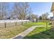 Large backyard with a wooden walkway and fence at 595 Hawthorne Dr, Carmel, IN 46033