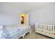 Pastel-colored bedroom with a crib and window at 595 Hawthorne Dr, Carmel, IN 46033