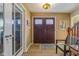 Inviting entryway with double doors and a charming sitting area at 595 Hawthorne Dr, Carmel, IN 46033