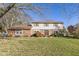 Brick two-story house with a spacious lawn and mature trees at 595 Hawthorne Dr, Carmel, IN 46033