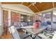 Relaxing screened porch with seating area and glass top table at 595 Hawthorne Dr, Carmel, IN 46033