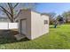 Large storage shed with roll-up door in backyard at 595 Hawthorne Dr, Carmel, IN 46033
