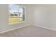 Bedroom with neutral walls, carpet, and a large window overlooking the street at 7149 Rose Hill Ave, Brownsburg, IN 46112