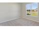 Bright bedroom with neutral walls and carpet, featuring a large window at 7149 Rose Hill Ave, Brownsburg, IN 46112