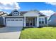 Craftsman style home with blue siding, white trim, and a two-car garage at 7149 Rose Hill Ave, Brownsburg, IN 46112