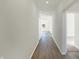 Long hallway with light walls and wood-look floors at 7149 Rose Hill Ave, Brownsburg, IN 46112