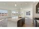 Bright kitchen with an island, stainless steel appliances, and views of the backyard at 7149 Rose Hill Ave, Brownsburg, IN 46112