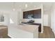 Modern kitchen features dark cabinetry, stainless steel appliances, and a large island at 7149 Rose Hill Ave, Brownsburg, IN 46112