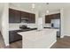 Modern kitchen with dark cabinets, stainless steel appliances and an island at 7149 Rose Hill Ave, Brownsburg, IN 46112