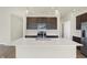 Modern kitchen with dark cabinets, stainless steel appliances and an island at 7149 Rose Hill Ave, Brownsburg, IN 46112