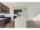 Modern kitchen with dark cabinets, stainless steel appliances, and an island at 7149 Rose Hill Ave, Brownsburg, IN 46112
