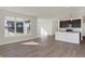 Open living room with large windows and wood-look floors at 7149 Rose Hill Ave, Brownsburg, IN 46112