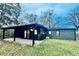 Newly painted home with a covered patio and well-maintained grass at 2442 N Franklin Rd, Indianapolis, IN 46219