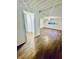 Finished basement with hardwood floors, recessed lighting, and access to storage at 2442 N Franklin Rd, Indianapolis, IN 46219