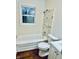 Clean bathroom with a bathtub, shower, and marble accents at 2442 N Franklin Rd, Indianapolis, IN 46219