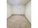 Well-lit bedroom with grey carpet and a window view at 2442 N Franklin Rd, Indianapolis, IN 46219