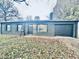 Ranch house with a black painted brick exterior, attached garage, and neatly kept lawn at 2442 N Franklin Rd, Indianapolis, IN 46219