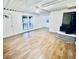Spacious living room featuring wood-look vinyl flooring, a wood-burning stove and large windows at 2442 N Franklin Rd, Indianapolis, IN 46219