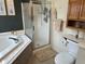 Bathroom with a bathtub, shower, and toilet at 11155 Baywood Ln, Indianapolis, IN 46236