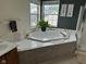Bathroom with corner bathtub and shower at 11155 Baywood Ln, Indianapolis, IN 46236
