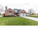 Brick house with two-car garage and landscaped lawn at 11155 Baywood Ln, Indianapolis, IN 46236