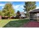 Landscaped backyard with large trees and screened porch at 12564 Geist Cove Dr, Indianapolis, IN 46236