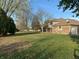 Brick home with spacious backyard, mature trees, and grassy lawn at 2413 Griton Ct, Shelbyville, IN 46176