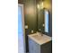 Modern bathroom with updated vanity, stylish mirror, and grey hexagon tile floor at 2413 Griton Ct, Shelbyville, IN 46176
