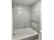 Elegant bathroom featuring a soaking tub and marble tile at 2413 Griton Ct, Shelbyville, IN 46176