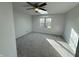 Bright bedroom with gray carpeting, skylight and large window at 2413 Griton Ct, Shelbyville, IN 46176