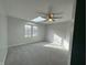 Bright bedroom with plush carpet, large window, and ceiling fan at 2413 Griton Ct, Shelbyville, IN 46176