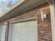 Three-car garage with brick exterior and new lighting at 2413 Griton Ct, Shelbyville, IN 46176