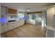 Open-concept kitchen with white cabinets, quartz countertops, and wood flooring at 2413 Griton Ct, Shelbyville, IN 46176