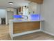 Modern kitchen features a large island with a wood-paneled front and quartz countertop at 2413 Griton Ct, Shelbyville, IN 46176