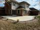 Large concrete patio with landscaping and exterior lighting at 2413 Griton Ct, Shelbyville, IN 46176