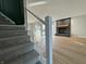 Modern staircase with gray carpeting and a cable railing at 2413 Griton Ct, Shelbyville, IN 46176