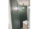 Stylish staircase featuring a dark green accent wall and a modern light fixture at 2413 Griton Ct, Shelbyville, IN 46176