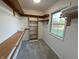 Bright walk-in closet with built-in shelves and hanging rods at 2413 Griton Ct, Shelbyville, IN 46176