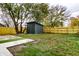 Backyard with shed, artificial turf, and wood fence at 1621 Draper St, Indianapolis, IN 46203