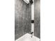 Basement bathroom with dark marble-look tile and sleek black fixtures at 1621 Draper St, Indianapolis, IN 46203