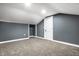Spacious basement bedroom with sloped ceiling, gray walls, and carpet flooring at 1621 Draper St, Indianapolis, IN 46203