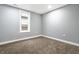 Simple, unfurnished basement bedroom with neutral walls and carpet at 1621 Draper St, Indianapolis, IN 46203
