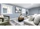 Bright basement living room with large artwork, comfy seating, and a stylish rug at 1621 Draper St, Indianapolis, IN 46203