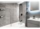 Modern bathroom with gray tile, a bathtub, and updated vanity at 1621 Draper St, Indianapolis, IN 46203