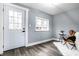 Bright entryway with a white door and gray walls, featuring hardwood floors at 1621 Draper St, Indianapolis, IN 46203