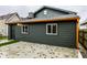 Rear view of house with dark-green siding and patio at 1621 Draper St, Indianapolis, IN 46203