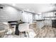 Modern kitchen with white cabinets, dark wood countertops, and black appliances at 1621 Draper St, Indianapolis, IN 46203