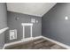 Small laundry room with gray walls and vinyl flooring at 1621 Draper St, Indianapolis, IN 46203
