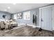 Spacious living room with light beige couch, hardwood floors, and large windows at 1621 Draper St, Indianapolis, IN 46203