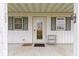 Inviting front porch with a glass door and green shutters at 26735 Six Points Rd, Sheridan, IN 46069